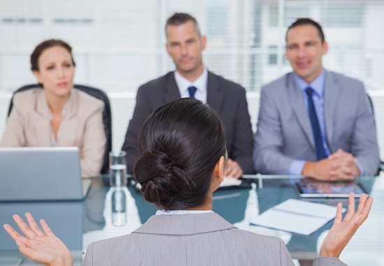 Woman being interviewed by three people