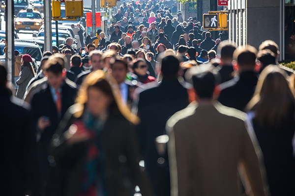 Image of many people on a crowded urban sidewalk