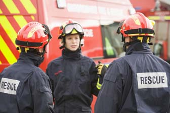 Emergency managment director standing outside a first response vehicle with rescue workers