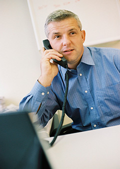 Sales manager using office phone. 