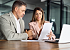 Female compliance officer showing a document to a male colleague