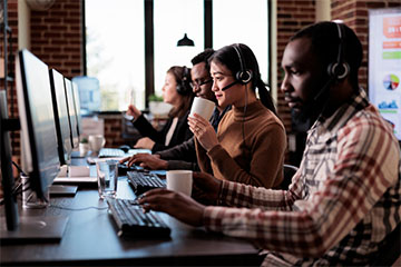 African American man working at call center office, as a bill and account collector, giving assistance and support on phone helpline. 