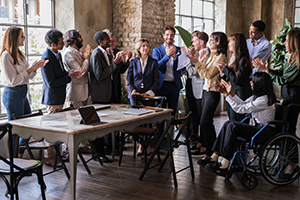 Diverse workers gathered around table image
