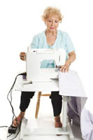 Woman using a pedal while operating a sewing machine