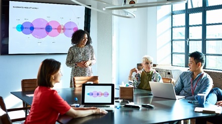 Stock image of a people attending a small meeting
